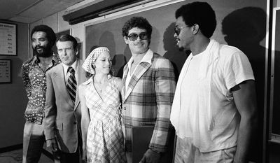 Washington Redskin head coach George Allen stands with two of his newly acquired running backs during a press conference at Redskins Park in Chantilly, Va., on Thursday, June 11, 1976.    From left are: Calvin Hill; Allen; Mrs. Mary Riggins; and John Riggins.  Mary Riggins is the wife of player Riggins.   (AP Photo/ Charles Harrity)