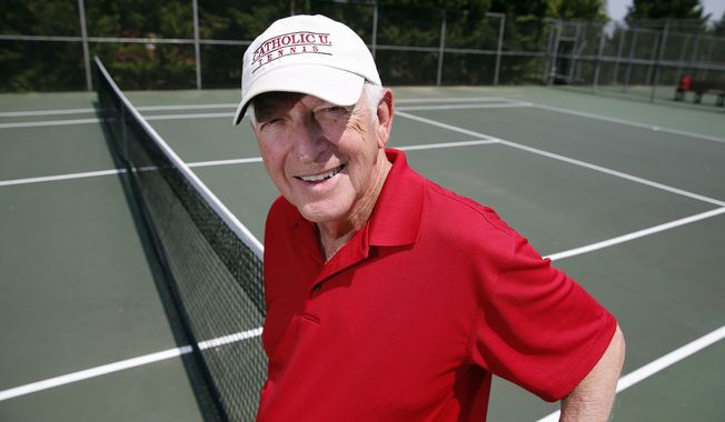 Marty Dowd, tennis coach for Catholic University of America, poses for a photograph, Thursday, May 8, 2014, in Washington. The 77-year-old coach led the Cardinals to the Landmark Conference title and a first-round match Friday against Washington &amp; Lee in the NCAA Division III tennis tournament. (AP Photo/Alex Brandon)
