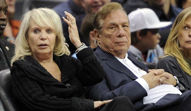 FILE - In this Nov. 12, 2010, file photo, Los Angeles Clippers owner Donald T. Sterling, right, sits with his wife Rochelle during the Clippers NBA basketball game against the Detroit Pistons in Los Angeles. An attorney representing the estranged wife of Clippers owner Donald Sterling said Thursday, May 8, 2014, that she will fight to retain her 50 percent ownership stake in the team.  (AP Photo/Mark J. Terrill, File)