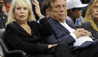 ** FILE ** In this Nov. 12, 2010, file photo, Los Angeles Clippers owner Donald T. Sterling, right, sits with his wife Rochelle during the Clippers NBA basketball game against the Detroit Pistons in Los Angeles. An attorney representing the estranged wife of Clippers owner Donald Sterling said Thursday, May 8, 2014, that she will fight to retain her 50 percent ownership stake in the team. (AP Photo/Mark J. Terrill, File)
