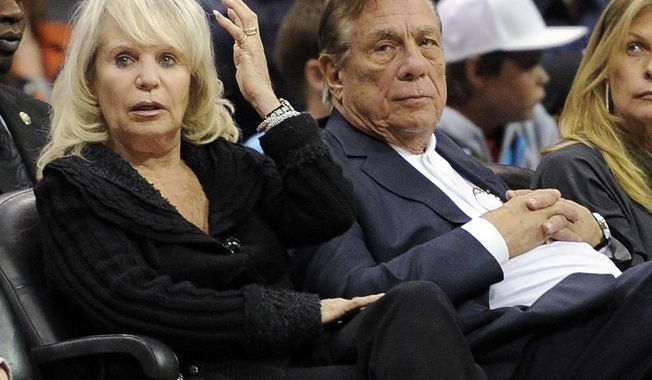 ** FILE ** In this Nov. 12, 2010, file photo, Los Angeles Clippers owner Donald T. Sterling, right, sits with his wife Rochelle during the Clippers NBA basketball game against the Detroit Pistons in Los Angeles. An attorney representing the estranged wife of Clippers owner Donald Sterling said Thursday, May 8, 2014, that she will fight to retain her 50 percent ownership stake in the team. (AP Photo/Mark J. Terrill, File)
