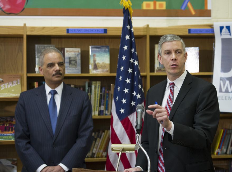 FILE - In this March 21, 2014, file photo, Education Secretary Arne Duncan, right, accompanied by Attorney General Eric Holder, speaks at J. Ormond Wilson Elementary School in Washington. The Obama administration said May 8 that troubling reports continue of school districts raising barriers to enrollment for children brought into the U.S. illegally. The Justice Department and Education Department issued new guidance reminding schools and districts they have a legal obligation to enroll every student regardless of their immigration status. The guidance says schools should be flexible in deciding which documents they will accept to prove a student’s age or residency.(AP Photo/Cliff Owen, File)