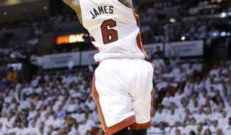 Miami Heat forward LeBron James dunks the ball during the first half of Game 2 of an Eastern Conference semifinal basketball game against the Brooklyn Nets, Thursday, May 8, 2014 in Miami. (AP Photo/Wilfredo Lee)
