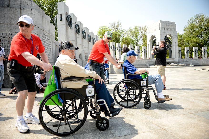 World War II veterans arrive at the World War II Memorial for a ceremony on V-E Day commemorating the 69th anniversary of the Allied Forces Victory in the Atlantic and the end of World War II in Europe, Washington, D.C., Thursday, May 8, 2014. The ceremony was held by The Friends of the National World War II Memorial and the National Park Service. (Andrew Harnik/The Washington Times)