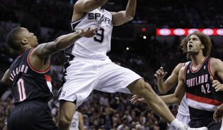 San Antonio Spurs&#39; Tony Parker (9), of France, drives around Portland Trail Blazers&#39; Damian Lillard (0) during the first half of Game 2 of a Western Conference semifinal NBA basketball playoff series, Thursday, May 8, 2014, in San Antonio.  (AP Photo/Eric Gay)
