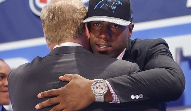 Missouri defensive end Kony Ealy hugs NFL commissioner Roger Goodell after being selected as the 60th pick by the Carolina Panthers in the second round of the 2014 NFL Draft, Friday, May 9, 2014, in New York. (AP Photo/Jason DeCrow)