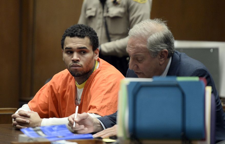 Chris Brown, left is shown in court with his attorney, Mark Geragos Friday May 9, 2014 in Los Angeles. Brown on Friday admitted a probation violation over an altercation last year outside a hotel in Washington, D.C., and was sentenced to remain on probation and serve an additional 131 days in jail. (AP Photo/Paul Buck, POOL)