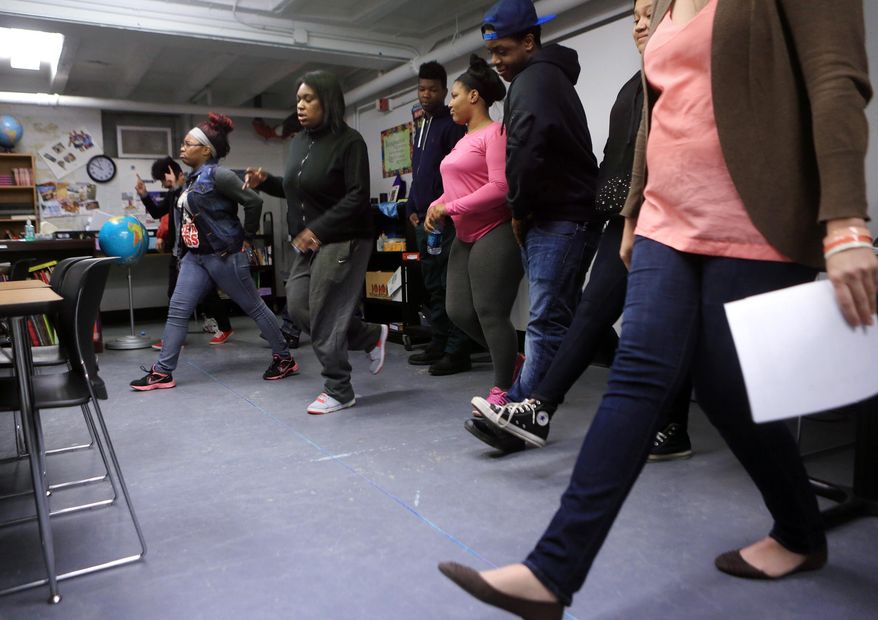 ADVANCE FOR RELEASE MONDAY, MAY 12, 2014, AND THEREAFTER- In this April 11, 2014 photo, students participate in a question and response action activity during a Teen Outreach Program lesson at MERC Alternative High School in Minneapolis. Sex education is part of the curriculum in every Minnesota high school. But 32 Hennepin County schools are expanding on the effort through the outreach program, known as TOP, which includes frank discussions on the biology of reproduction and also on healthy relationships. (AP Photo/Minnesota Public Radio, Jeffrey Thompson)