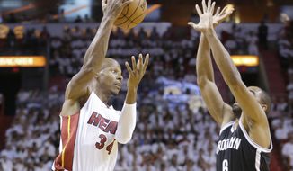 Miami Heat guard Ray Allen (34) attempts to pass past Brooklyn Nets forward Alan Anderson (6) during the first half of Game 2 of an Eastern Conference semifinal basketball game, Thursday, May 8, 2014 in Miami. (AP Photo/Wilfredo Lee)