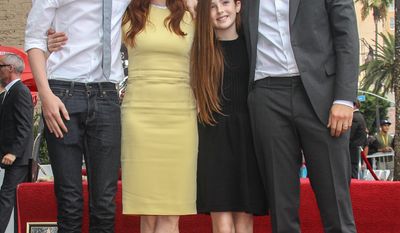 Actress Julianne Moore, second left, and husband, director Bart Freundlich, right, and children Liv and Caleb attend Moore&#39;s star ceremony as she is honored on the Hollywood Walk of Fame on Thursday, Oct. 3, 2013, in Los Angeles. (Photo by Paul A. Hebert/Invision/AP)