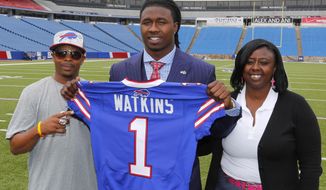 Buffalo Bills first round draft pick Sammy Watkins poses for photos with his father James McMiller, left, and mother Nicole McMiller at Ralph Wilson Stadium in Orchard Park, N.Y., Friday, May 9, 2014. (AP Photo/Bill Wippert)