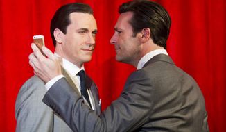 Jon Hamm, right, takes a selfie at the unveiling of his wax figure at Madame Tussauds on Friday, May 9, 2014 in New York. (Photo by Charles Sykes/Invision/AP)