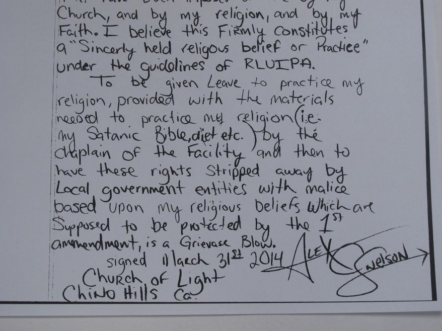 This May 9, 2014, photo,shows the closing of a hand-written lawsuit filed by Alex C. Snelson, a Nevada inmate who practices Satanism and accuses the Washoe County jail of violating his right to freely exercise his religion. Snelson, 33, said in the amended complaint filed in U.S. District Court in Reno on Wednesday that he's been denied meals that adhere to his religious diet. (AP Photo/Scott Sonner).