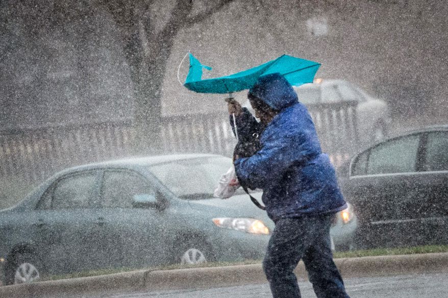 Nou Katzmarek tries to shield herself from an afternoon downpour in Savage, Min., Thursday, May 8, 2014 Thunderstorms are moving across the Plains, bringing strong winds and dropping several tornadoes on the ground in south-central Minnesota, but no major damage or injuries are reported. (AP Photo/The Star Tribune, Glenn Stubbe) MANDATORY CREDIT; ST. PAUL PIONEER PRESS OUT; MAGS OUT; TWIN CITIES TV OUT