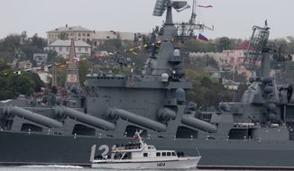 Russian President Vladimir Putin, on a boat, inspects the missile cruiser Moskva during a navy parade marking the Victory Day in Sevastopol, Crimea, Friday, May 9, 2014. Putin extolled the return of Crimea to Russia before tens of thousands Friday during his first trip to Black Sea peninsula since its annexation.  The triumphant visit was quickly condemned by Ukraine and NATO.  (AP Photo / Ivan Sekretarev) ** FILE **