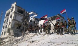 FILE - In this Wednesday, June 5, 2013 file photo released by the Syrian official news agency SANA, Syrian army troops hold up national flags in the town of Qusair, near the Lebanon border, Homs province, Syria. Two years ago, it seemed almost inevitable that President Bashar Assad would be toppled. Almost no one thinks that now. As he prepares for elections through which he is set to claim another seven-year mandate for himself, the momentum in the civil war is clearly in Assad&#39;s favor. (AP Photo/SANA, File)