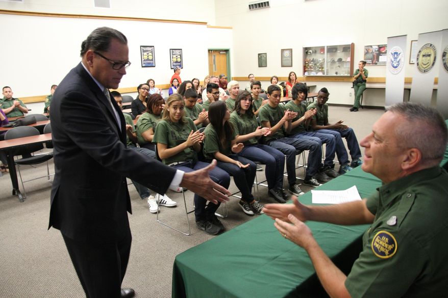 Texas state Sen. Jose Rodriguez greets Border Patrol Division Chief Michael Przybyl after addressing high school students that graduated from at-risk youth program at the Border Patrol station in El Paso, Texas, Friday, May 09, 2014. Twelve teenagers referred by truancy court graduated Friday from the five-week REAL program in which Border Patrol agents mentor them through physical training, community service and presentations at other local institutions like a jail tour. (AP Photo/Juan Carlos Llorca)