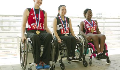 Winners of the University Interscholastic League&#x27;s first-ever girls wheelchair seated shot put event, from left, Abby Dunkin, from New Braunfels, gold; Kortney Boldt, from Steele High School in Cibolo, silver, and Brandi Smith, from Rowlett, bronze, sit together after competing in the UIL Track and Field State Championships at the Mike A. Myers Stadium at The University of Texas at Austin on Saturday, May 10, 2014. (AP Photo/Austin American-Statesman, Ralph Barrera)