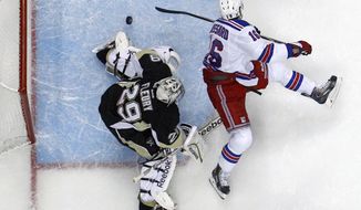 New York Rangers&#39; Derick Brassard (16) backhands a shot past Pittsburgh Penguins goalie Marc-Andre Fleury (29) in the first period of Game 5 of a second-round NHL playoff hockey series in Pittsburgh, Friday, May 9, 2014. The Rangers won 5-1. (AP Photo/Gene J. Puskar)