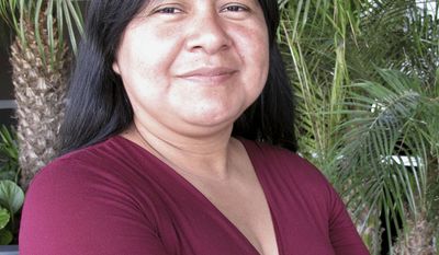 In this April 23, 2014 photo, Silvia Lopez, a farmworker at Gerawan Farming, Inc., poses for a photograph in Fresno, Calif. Lopez, 38, led a petition last year to hold a vote among workers, hoping to reject representation by the United Farm Workers. The votes have yet to be counted, and the case is playing out in court. (AP Photo/Scott Smith)