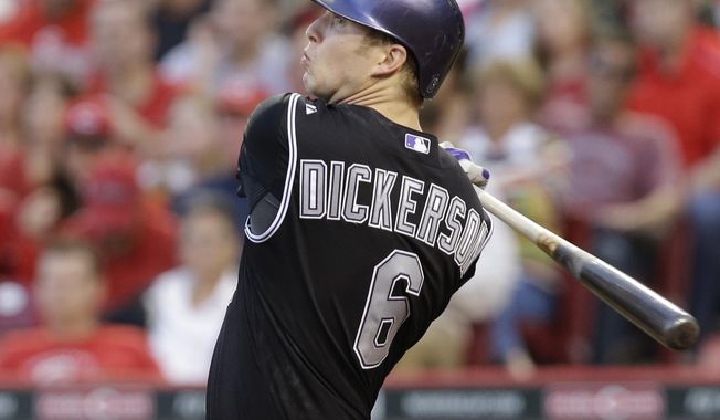 Colorado Rockies&#x27; Corey Dickerson hits a double off Cincinnati Reds relief pitcher Nick Christiani to drive in a run in the fourth inning of a baseball game, Saturday, May 10, 2014, in Cincinnati. (AP Photo/Al Behrman)