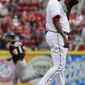 Cincinnati Reds starting pitcher Alfredo Simon, right, stands on the mound after giving up a home run to Colorado Rockies&#x27; Corey Dickerson (6) in the first inning of a baseball game on Saturday, May 10, 2014, in Cincinnati. (AP Photo/Al Behrman)