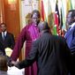 South Sudan&#39;s President Salva Kiir, left, and rebel leader Riek Machar, right, shake hands and pray before signing an agreement of the cease-fire of the conflict in South Sudan in Addis Ababa, Ethiopia,  Friday, May 9, 2014. (AP Photo/Elias Asmare) ** FILE **