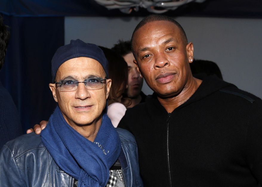 FILE - This Feb. 10, 2013 file photo shows music industry entrepreneur Jimmy Iovine, left, and hip-hop mogul Dr. Dre at a Grammy Party in Los Angeles. It’s as if anything Iovine and Dre touches turns to gold: The dynamic duo marked epic-level success when they introduced Eminem to the music world 15 years ago, and their lucrative Beats by Dre business reached blockbuster heights following reports on Thursday, May 8, 2014, that Apple plans to by the headphone’s parent company, Beats Electronics, for $3.2 billion.  (Photo by Todd Williamson/Invision/AP, file)