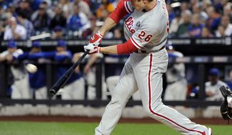 Philadelphia Phillies&#x27; Chase Utley hits a sacrifice fly to score Ben Revere during the first inning of a baseball game against the Ne York Mets, Saturday, May 10, 2014, at Citi Field in New York. (AP Photo/Bill Kostroun)