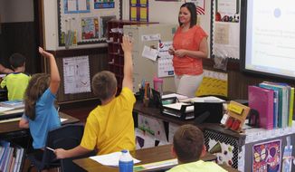 In this Wednesday, Sept. 18, 2013 file photo, Shelly Ellis teaches fourth-grade students in a classroom at Bement Elementary School in Bement, Ill.  (AP Photo/David Mercer) ** FILE **