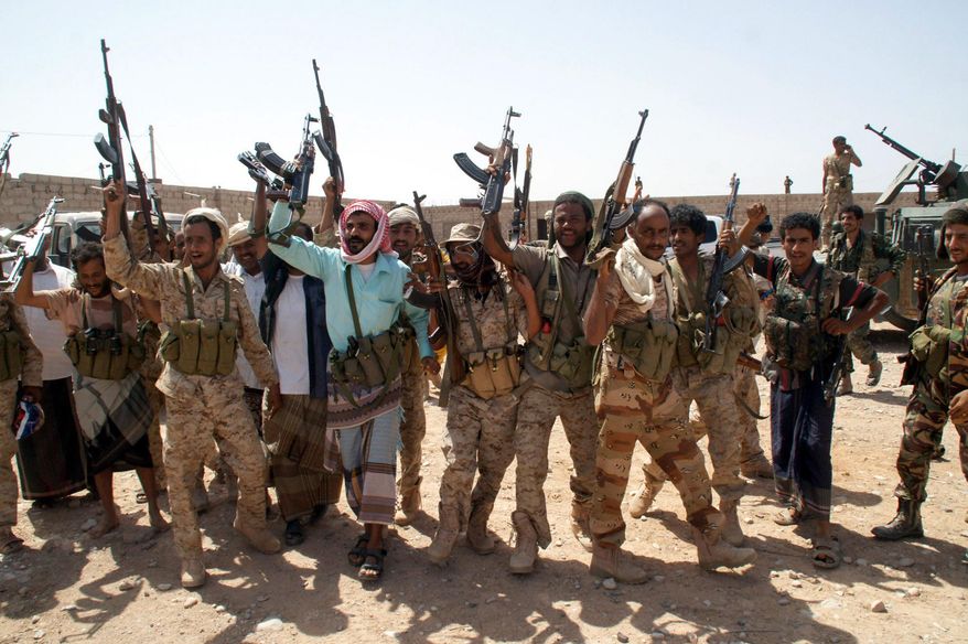 In this photo provided by Yemen&#39;s Defense Ministry, Yemen&#39;s army soldiers hold up their weapons at an area seized from al-Qaida in the southeastern province of Shabwa, Yemen, Thursday, May 8, 2014. Yemeni armed forces on Thursday swept al-Qaida fighters out of a district in the country&#39;s south, one of the main goals of the major offensive waged by the military the past two weeks, the Defense Ministry said, amid fears of retaliatory attacks which officials say prompted the closure of the US embassy in the capital as a precaution. (AP Photo/Yemen&#39;s Defense Ministry)