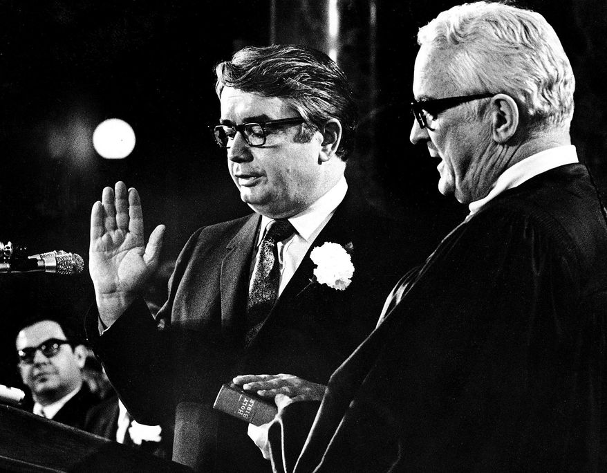 In this Jan. 4, 1971 photo, Patrick Lucey, center, is sworn in as Wisconsin Governor by Judge E. Harold Hallows, in Madison, Wis. Lucey, a hard-nosed Democratic politician who later became ambassador to Mexico, died Saturday, May 10, 2014. He was 96. (AP Photo/Wisconsin State Journal, Ed Stein)