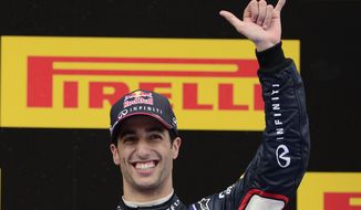 Red Bull driver Daniel Ricciardo of Australia celebrates his third position on the podium at the end of the Spain Formula One Grand Prix at the Barcelona Catalunya racetrack in Montmelo, near Barcelona, Spain, Sunday, May 11, 2014.(AP Photo/Manu Fernandez)