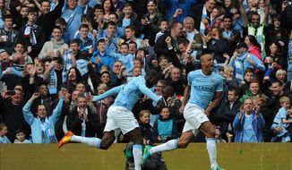 Manchester City&#x27;s Vincent Kompany, right, celebrates after scoring against West Ham during the English Premier League soccer match between Manchester City and West Ham United at the Etihad Stadium, Manchester, England, Sunday, May 11, 2014. (AP Photo/Rui Vieira)