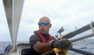 In this undated photo provided by G.C. Media, Victor Mooney rows the Spirit of Malabo in the Atlantic Ocean. Mooney who hopes to cross the Atlantic Ocean in honor of his brother who died of AIDS in 1983, passed the halfway mark, Sunday, May 11, 2014. He has tried the same feat three other times, without success. (AP Photo/G.C. Media)