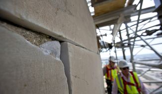 This June 2, 2013, file photo shows a damaged stone on the Washington Monument at the 491-foot level of the scaffolding surrounding the monument, in Washington. The monument, which sustained damage from an earthquake in August 2011, reopened to the public on Monday, May 12, 2014. (AP Photo/Alex Brandon, File)