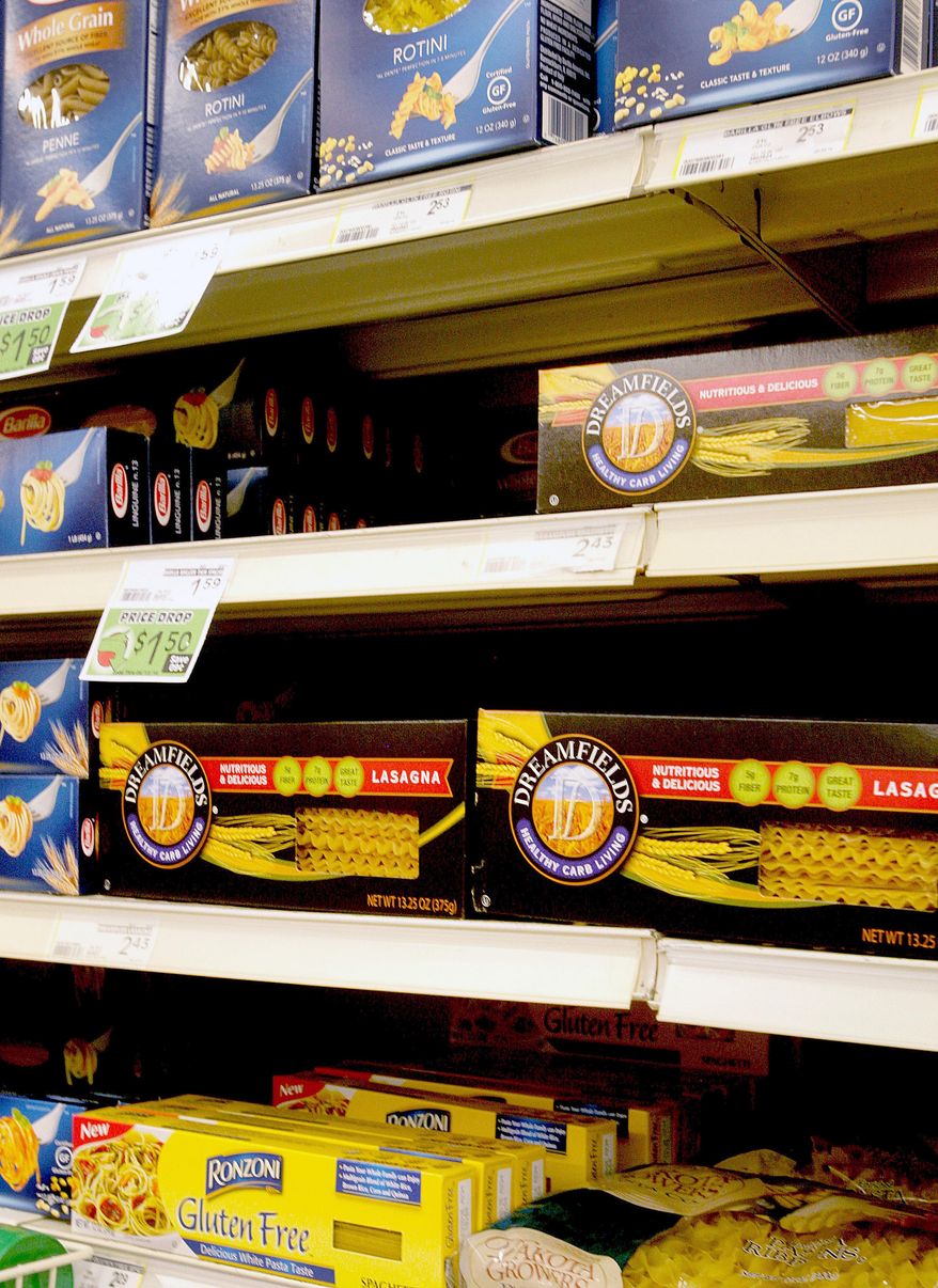 In this May 9, 2014 photo, Dreamfields Pasta is seen on the shelves of a grocery store in Farno, N.D. A company accused of falsely advertising the health benefits of its nationally distributed Dreamfields Pasta has agreed to pay $5 million to consumers as part of a class-action settlement. The complaint accuses Carrington, North Dakota-based Dakota Growers Pasta and its parent company of bogus claims that the product was a low-carbohydrate alternative to traditional pasta. (AP Photo/Bruce Crummy)