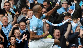 Manchester City&#x27;s Vincent Kompany celebrates with fans after scoring against West Ham during the English Premier League soccer match between Manchester City and West Ham United at the Etihad Stadium,  Manchester, England, Sunday, May 11, 2014. (AP Photo/Rui Vieira)
