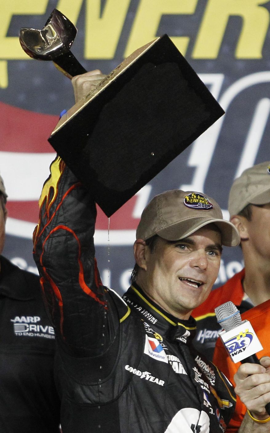 NASCAR driver Jeff Gordon celebrates in victory lane after winning the Sprint Cup Series auto race at Kansas Speedway in Kansas City, Kan., Saturday, May 10, 2014. (AP Photo/Colin E. Braley)