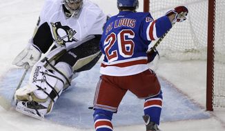New York Rangers right wing Martin St. Louis (26) scores against Pittsburgh Penguins goalie Marc-Andre Fleury during the first period of Game 6 of a second-round NHL playoff hockey series on Sunday, May 11, 2014, in New York. (AP Photo/Seth Wenig)