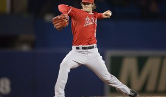 Los Angeles Angels starting pitcher C.J. Wilson pitches against the Toronto Blue Jays during first inning American League baseball action in Toronto on Monday, May 12, 2014.  (AP Photo/The Canadian Press, Frank Gunn)