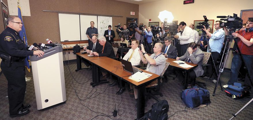 Janesville, Wi. Police Chief David Moore, left, speaks during a news conference on Monday, May 12, 2014. Janesville has become a center of interest in the last 10 days, as it investigates an attempted murder, the discovery of the body of a young woman, and the disappearance of two other people. The body of one of those missing people was found in the Rock River last Friday and the other person was found alive and well in northern Wisconsin earlier today. (AP Photo/The Janesville Gazette, Bill Olmsted)