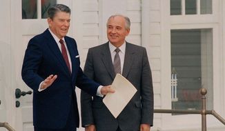 U.S. President Ronald Reagan gestures as Soviet leader Mikhail Gorbachev looks on after their third session of talks at the Hofdi in Reykjavik, Oct. 12, 1986. (AP Photo/Ron Edmonds)