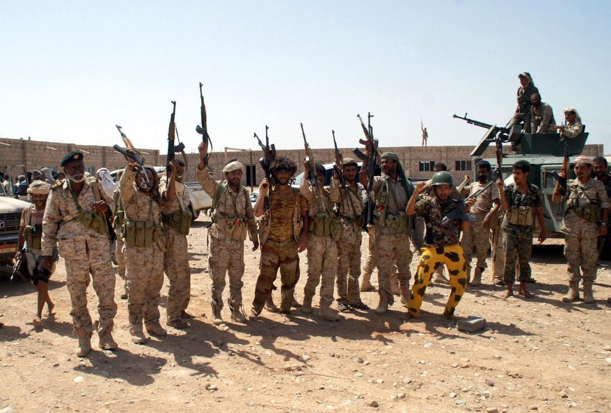 In this photo provided by Yemen&#39;s Defense Ministry, Yemen&#39;s army soldiers hold up their weapons at an area seized from al-Qaida in the southeastern province of Shabwa, Yemen, Thursday, May 8, 2014. Yemeni armed forces on Thursday swept al-Qaida fighters out of a district in the country&#39;s south, one of the main goals of the major offensive waged by the military the past two weeks, the Defense Ministry said, amid fears of retaliatory attacks which officials say prompted the closure of the U.S. Embassy in the capital as a precaution. (AP Photo/Yemen&#39;s Defense Ministry)