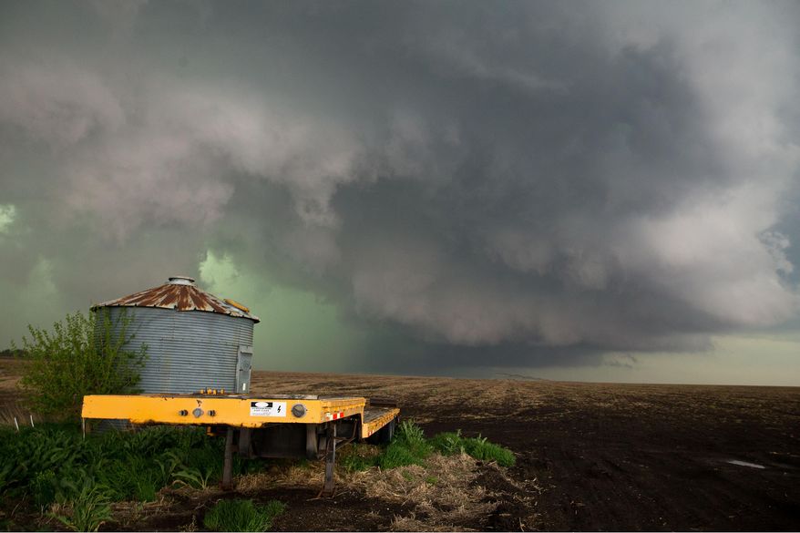 CORRECTS CREDIT TO CHRIS MACHIAN - In this Sunday May 11, 2014 photo, a wall cloud that spawned a tornado warning forms northwest of Dorchester Neb. Sunday's storms caused damage across much of eastern Nebraska roughly on a line from the Kansas border up through Hastings and Omaha. No serious injuries were reported. (AP Photo/The World-Herald, Chris Machian) MAGS OUT TV OUT