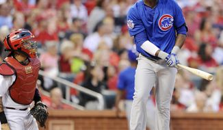 Chicago Cubs&#39; Junior Lake, right, watches his three-run home run as St. Louis Cardinals&#39; Yadier Molina, left, looks on in the second inning in a baseball game, Monday, May 12, 2014, at Busch Stadium in St. Louis. (AP Photo/Bill Boyce)