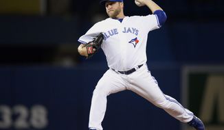 Toronto Blue Jays starting pitcher Mark Buehrle pitches against the Los Angeles Angels during first inning American League baseball action in Toronto on Monday, May 12, 2014. (AP Photo/The Canadian Press, Frank Gunn)