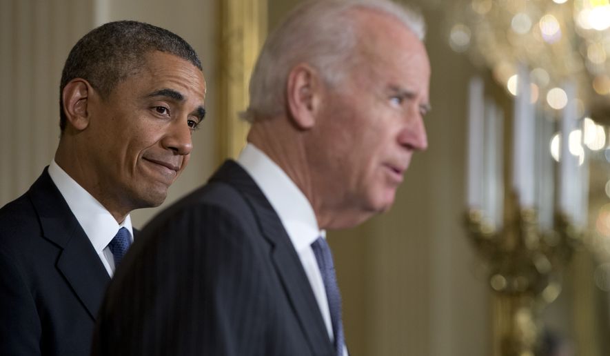 President Obama, left, looks to Vice President Joe Biden as he speaks at a ceremony in East Room of the White House in Washington, May 12, 2014. (Associated Press) ** FILE **