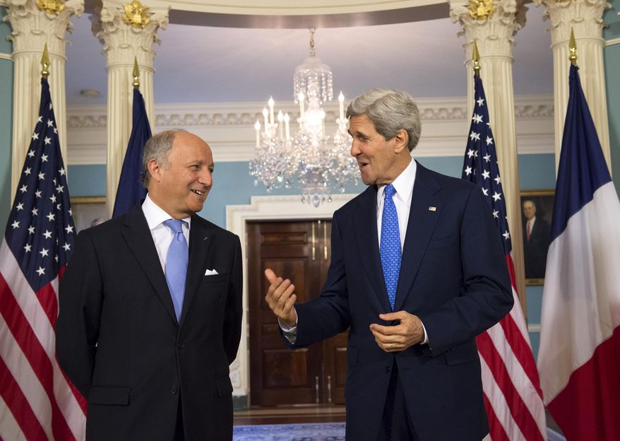 Secretary of State John Kerry and French Foreign Minister Laurent Fabius speak prior to their meeting at the State Department in Washington, Tuesday, May 13, 2014. (AP Photo/Molly Riley)