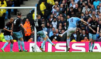 Manchester City&#x27;s Samir Nasri, second right, scores his side&#x27;s first goal during the English Premier League soccer match between Manchester City and West Ham at the Etihad Stadium in Manchester, England, Sunday May 11, 2014.  (AP Photo/Jon Super)